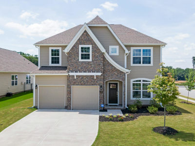 New house with a green lawn.